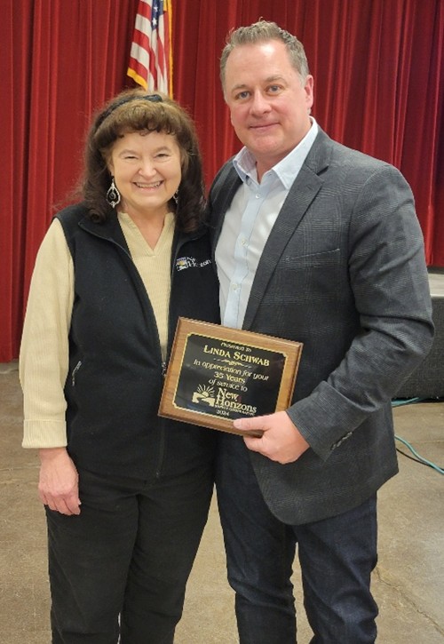 Linda Schwab with CEO Jason Cullen, receiving a plaque for 35 Years of Service